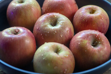 Top view of fugi apples in a blue bowl