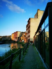 The old town houses with footbridge over Mlynowka river and Mill Island boardwalk alley, Bydgoszcz, Poland