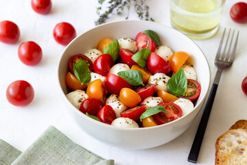 Salad with mozzarella, tomatoes and basil. Healthy eating. Vegetarian food.