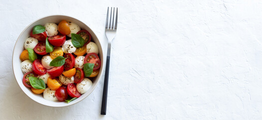 Salad with mozzarella, tomatoes and basil. Healthy eating. Vegetarian food.