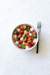 Salad with mozzarella, tomatoes and basil. Healthy eating. Vegetarian food.