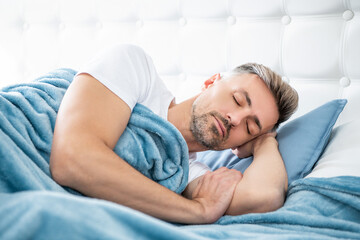 mature man having siesta in bed. early morning - obrazy, fototapety, plakaty