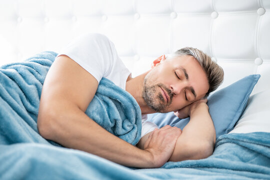 mature man having siesta in bed. early morning