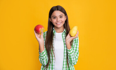 happy girl with apple and pear fruit on yellow background