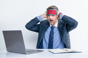 tired shocked boss yawning in sleep mask at workplace