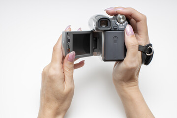 female hand opens the rotary screen of an old video camera
