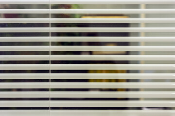 White office blinds cover the glass partition in the room. For use as a background.