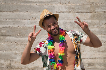 Young and handsome man, blue eyes, perfect smile, with beard, hat, open Hawaiian shirt and flower...