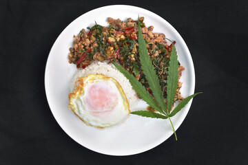  Rice and topped with stir - fried Beef and basil with Cannabis leaf