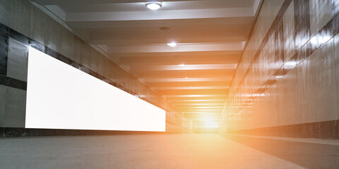 Advertising long banner fixed on wall of subway crossing side view. Public announcement and mockup space.