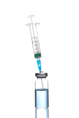 Vaccine bottle with blue liquid and syringe isolated on white background with reflection