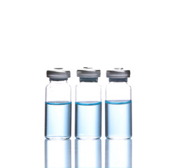 Vaccine bottles with blue liquid isolated on white background with reflection