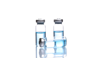 Vaccine bottles with blue liquid isolated on white background with reflection