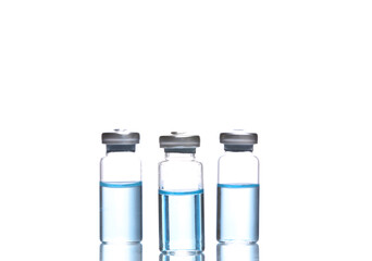 Vaccine bottles with blue liquid isolated on white background with reflection