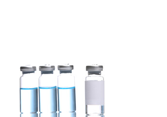 Vaccine bottles with blue liquid and bottle with blank label  isolated on white background with reflection