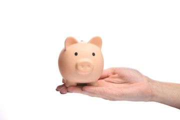 Piggy bank on the palm of the hand isolated on white background