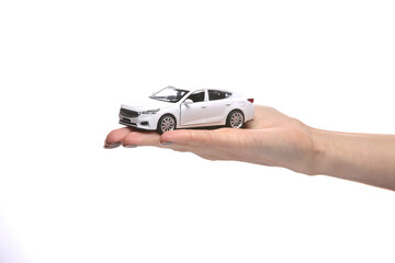 Toy car model on the palm of the hand isolated on white background