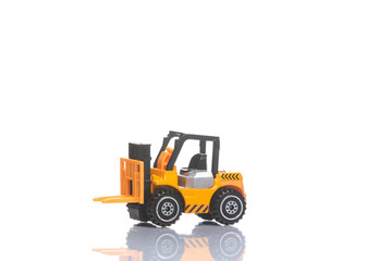 Toy forklift model isolated on white background with reflection