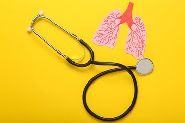 Paper-cut anatomical human lungs with stethoscope on yellow background. Diagnosis of pulmonary...