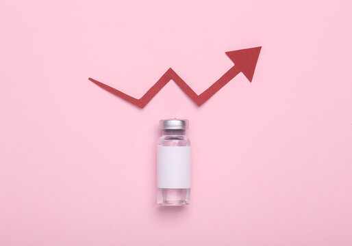 Vaccine bottle with a blank label for brand and growth arrow on pink background. Covid 19 vaccination
