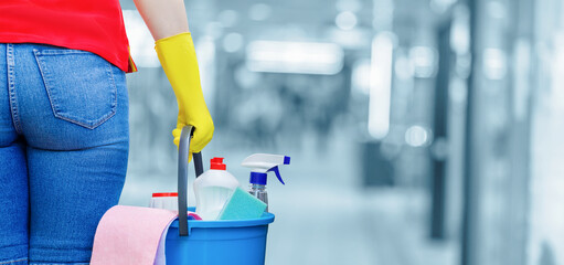 Cleaner with bucket and cleaning products .