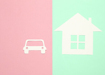 Paper-cut house and car on a blue-pink background. Property