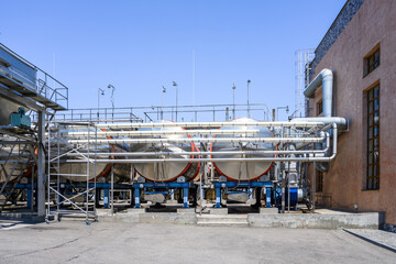 Wine steel tanks, equipment of contemporary winemaker factory.  Barrels for wine storage. Equipment for the fermentation, distillation of alcohol. Preparation workshop for pure alcohols.
