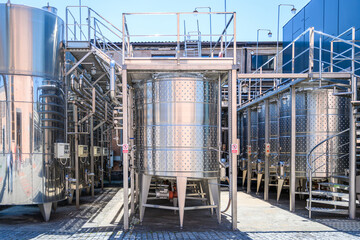 Wine steel tanks, equipment of contemporary winemaker factory.  Barrels for wine storage.