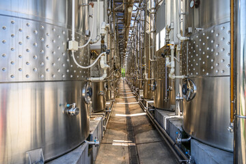 Wine steel tanks, equipment of contemporary winemaker factory.  Barrels for wine storage.