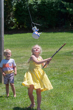 Girl Swings And Breaks Open A Pinata