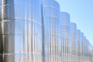 Wine steel tanks, equipment of contemporary winemaker factory.  Barrels for wine storage. Equipment...