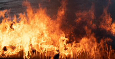 Flames. Firewood firing is part of the black ceramic process. Unique hand-made pots and pans made...