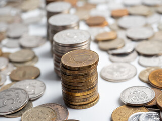 Close-up of a lot of Russian ruble coins on a white background. Columns of coins. The concept of the economy of growth, development. Budget, currency. Risks, banks
