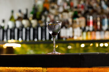 Aviation, drink with gin, lemon juice, maraschino liqueur and violet cream liqueur standing on bar counter.