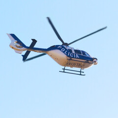 Surveying the area. Low angle shot of a police helicopter in the sky.