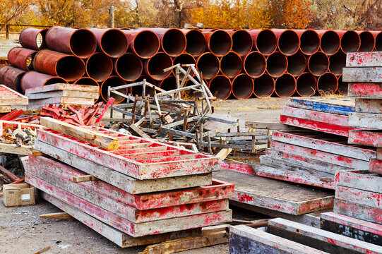 construction formwork and pipes stacked on an open warehouse