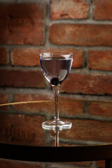 Aviation, drink with gin, lemon juice, maraschino liqueur and violet cream liqueur standing on bar counter.