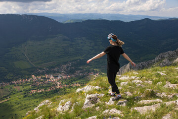 woman in the mountains. Rimetea from above. 
Rimetea village seen from Piatra Secuiului.