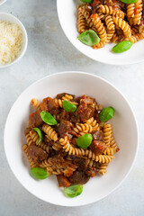 Pasta alla Norma - traditional Italian food with eggplant, tomato, cheese and basil