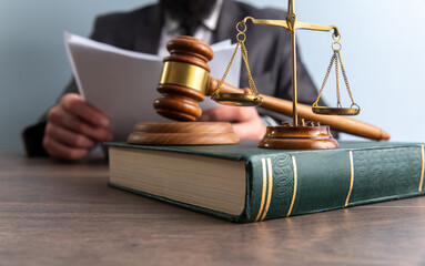  Business and lawyers discussing contract papers with brass scale on desk