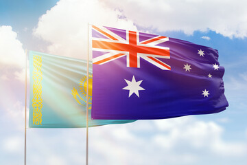 Sunny blue sky and flags of australia and kazakhstan