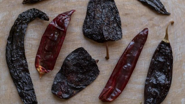 Dried chili peppers: Guajillo, Ancho and Pasilla top view. Table spin.