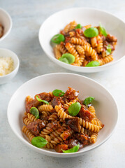 Pasta alla Norma - traditional Italian food with eggplant, tomato, cheese and basil