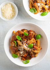 Pasta alla Norma - traditional Italian food with eggplant, tomato, cheese and basil