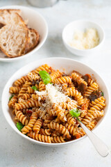 Pasta alla Norma - traditional Italian food with eggplant, tomato, cheese and basil