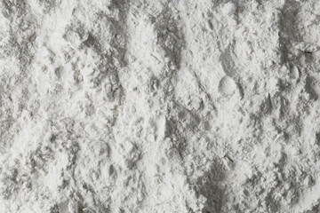 Wheat flour scattered on the table. Flour texture.