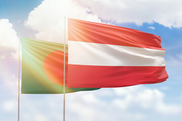 Sunny blue sky and flags of austria and bangladesh