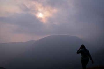 silhouette of a person in the mountains