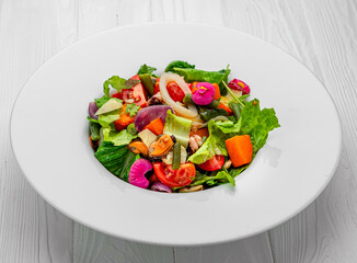Salad with seafood and fresh vegetables. Healthy salad plate.