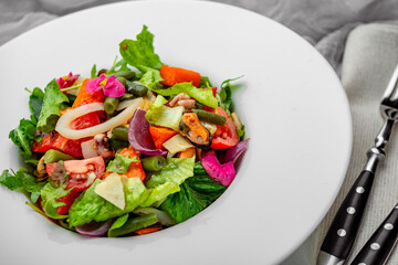 Salad with seafood and fresh vegetables. Healthy salad plate.